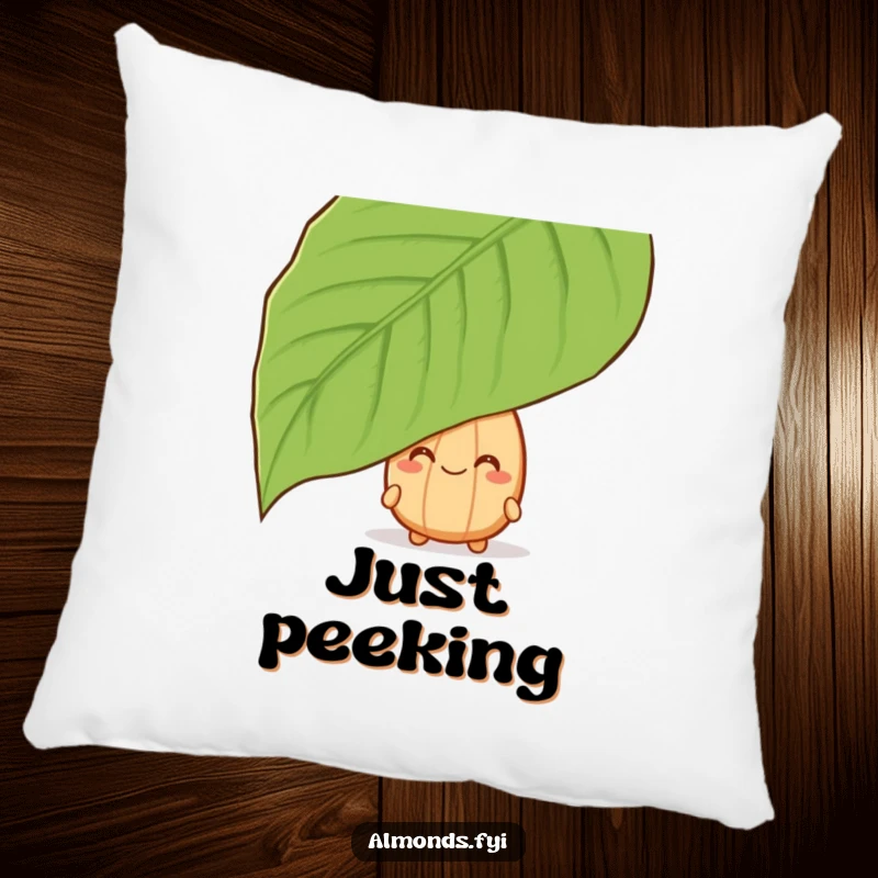 Funny pillow featuring a grinning almond character peeking from behind a leaf, offering cozy, secretive humor.