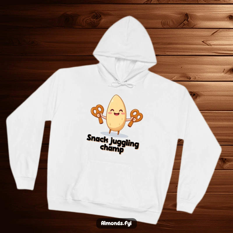 Funny hoodie displaying a gleeful almond character confidently juggling three giant pretzel sticks, radiating happiness.