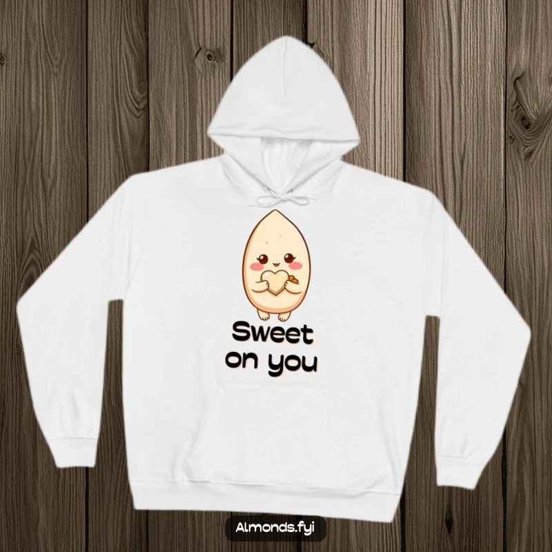 Funny hoodie illustrating a blushing almond character lovingly holding a small, delicate heart-shaped nut.