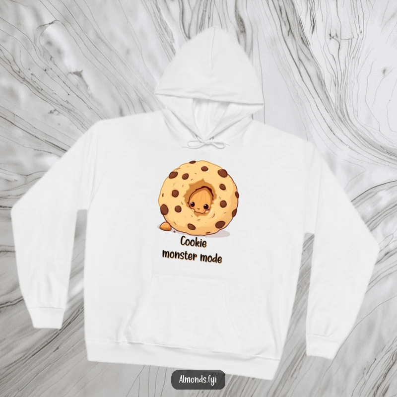 Funny hoodie with a curious almond character peeking from behind an oversized cookie crumb, looking playfully sneaky and intrigued.