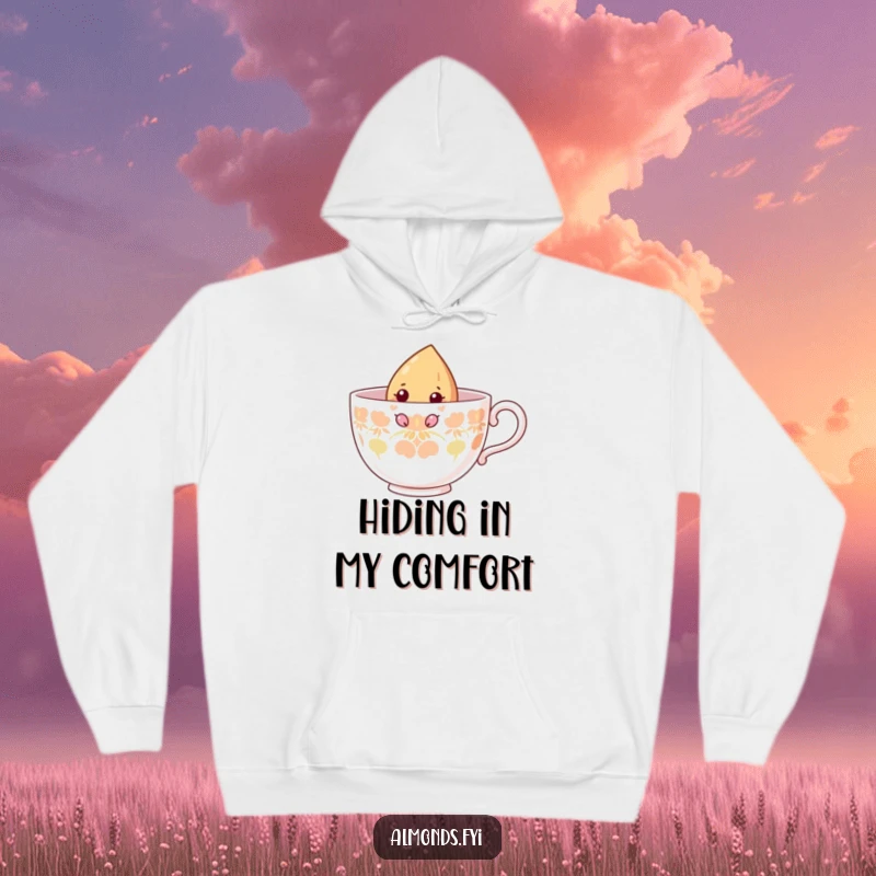Funny hoodie with a curious almond character peeking out of a large teacup, embodying a sense of gentle exploration.